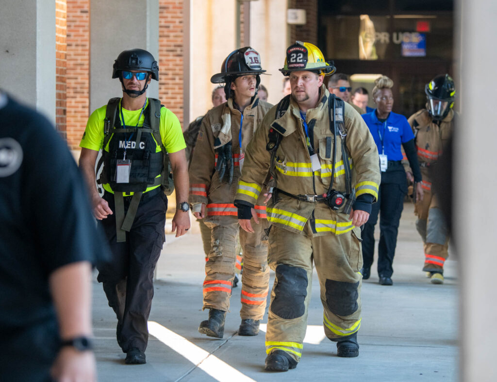 First responders in uniform participate in a tribute climb.