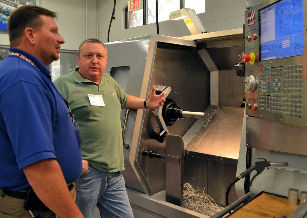 WCC Computer-Integrated Machining Instructor Ted Koger (left) talks shop with fellow instructor Jerry Hunt from Rowan-Cabarrus Community College during the first day of the N.C. Association of Machinist Instructors annual conference.