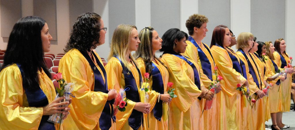 Graduates stand for oath