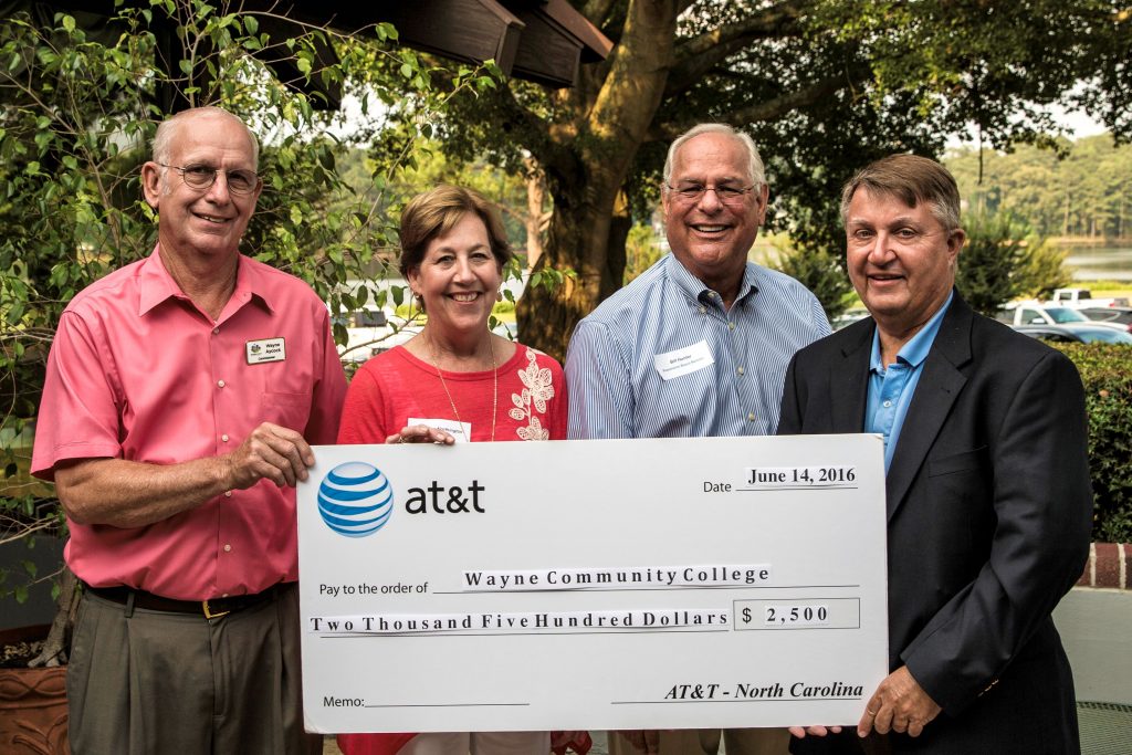 AT&T Regional Director for External Affairs John Lyon (far right) accompanied by Wayne County Commissioner and WCC Trustee Wayne Aycock (far left), recently presented a $2,500 contribution to Foundation of Wayne Community College Executive Director Adrienne Northington (center left) and Foundation Chair Bill Hunter (center right) for scholarships for military veterans and their families.