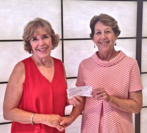 Beverly Carroll of the Sunrise Kiwanis Club (left) presents Foundation of Wayne Community College Executive Director Adrienne Northington a $1,000 donation in memory of past club members. The money is to be used for scholarships for WCC students.