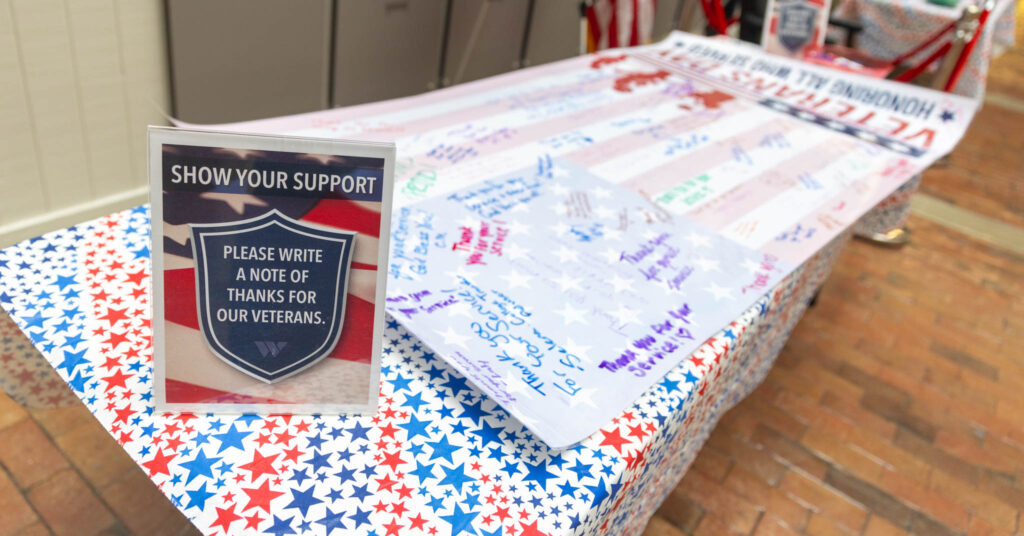 A banner with signatures lays on a table.