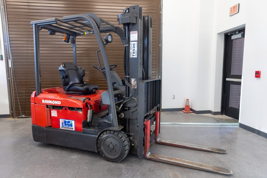 An image of a red and black forklift is shown.